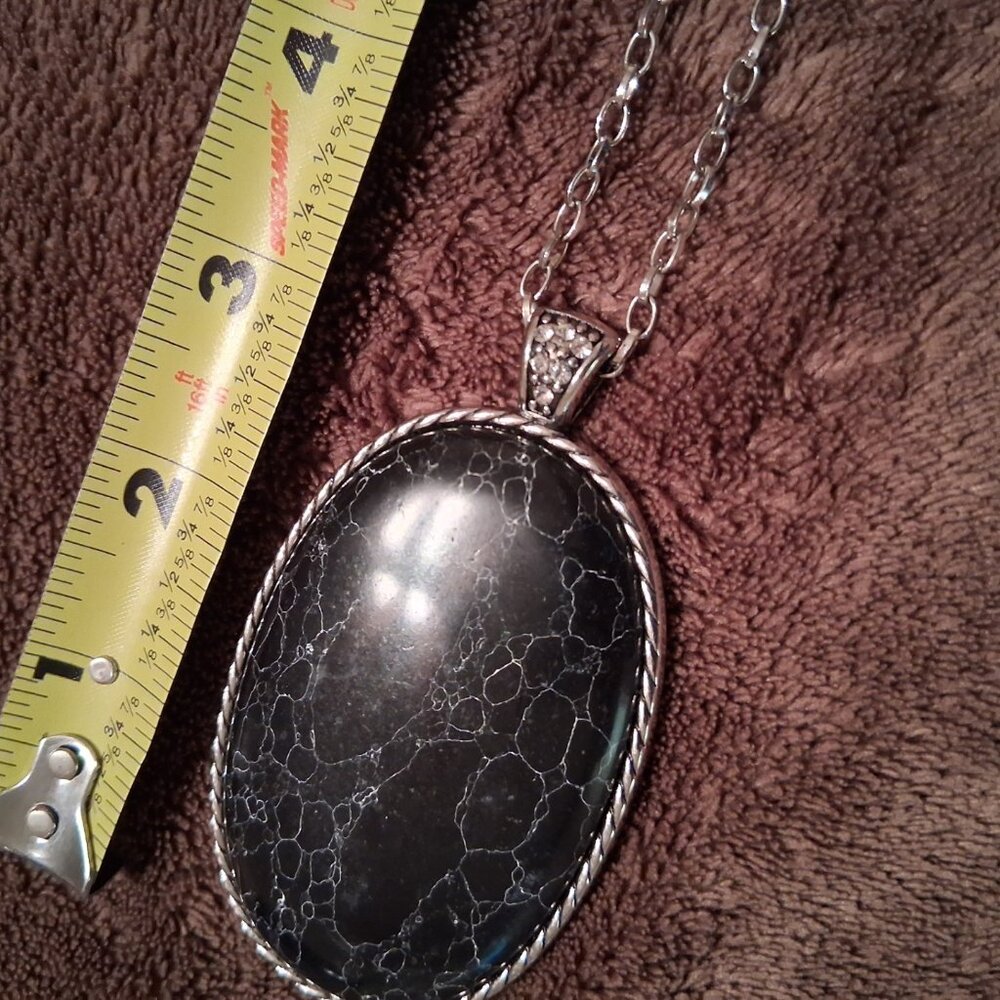Large black medallion